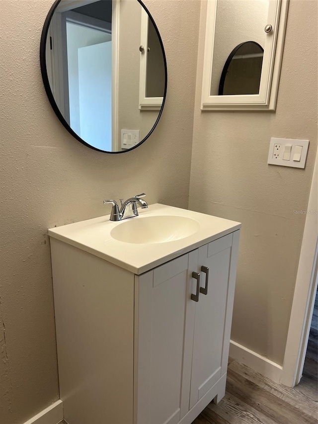 bathroom with vanity and wood-type flooring