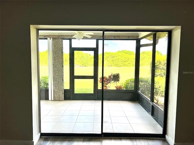 doorway to outside featuring plenty of natural light and ceiling fan