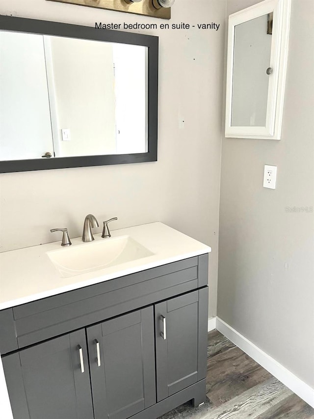 bathroom with vanity and hardwood / wood-style floors