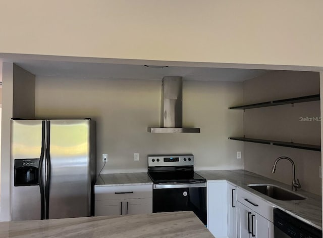 kitchen featuring sink, appliances with stainless steel finishes, white cabinetry, light stone counters, and wall chimney exhaust hood