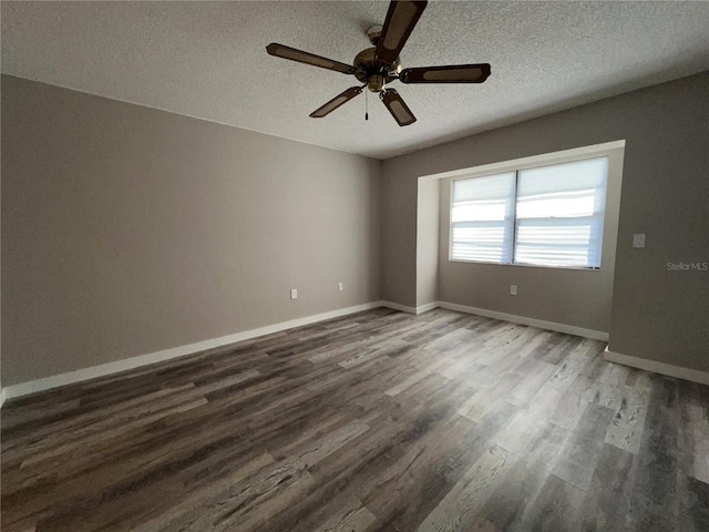 unfurnished room with a textured ceiling, ceiling fan, wood finished floors, and baseboards