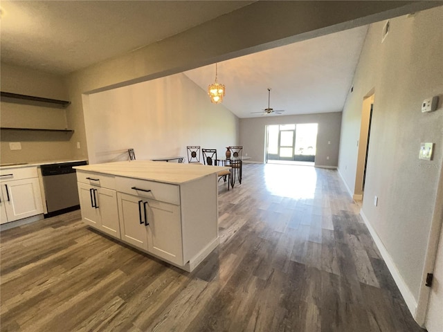 kitchen featuring dark wood finished floors, white cabinets, stainless steel dishwasher, and light countertops