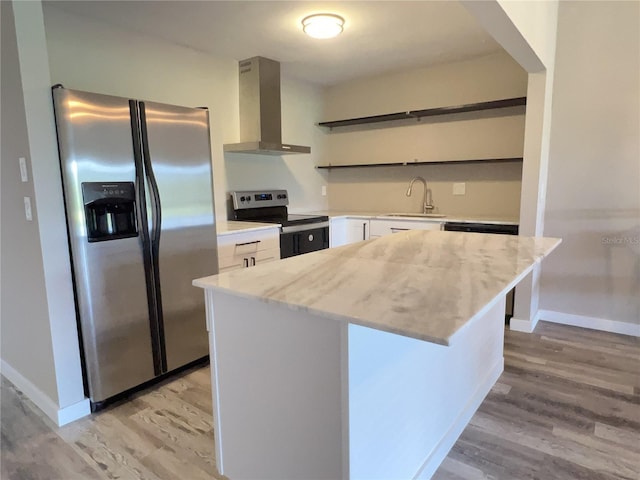 kitchen with open shelves, stainless steel appliances, white cabinets, a sink, and wall chimney exhaust hood