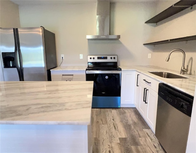 kitchen featuring stainless steel appliances, open shelves, a sink, white cabinets, and wall chimney exhaust hood