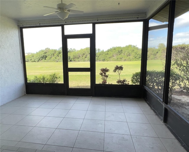 unfurnished sunroom with a ceiling fan