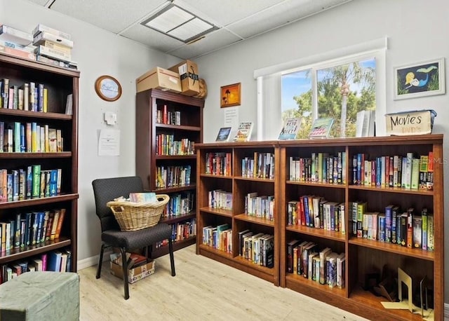 sitting room featuring a paneled ceiling and wood finished floors