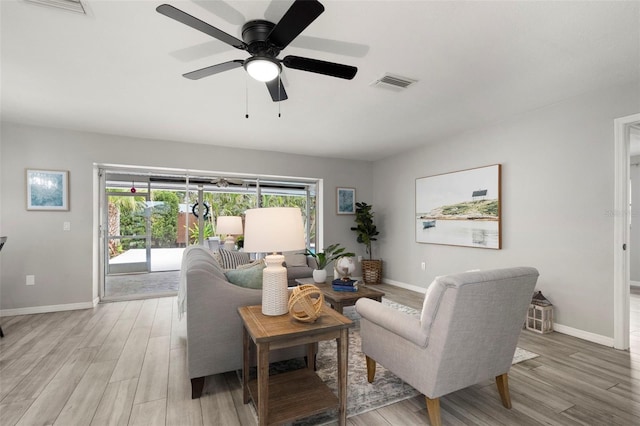 living room with ceiling fan and light hardwood / wood-style floors