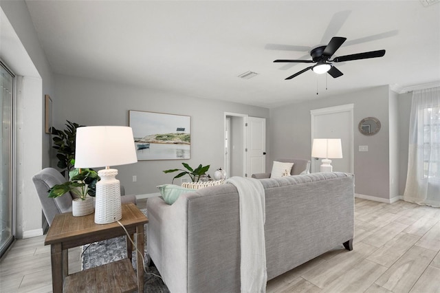 living room featuring light hardwood / wood-style floors and ceiling fan