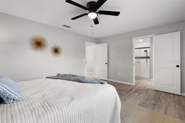 bedroom with connected bathroom, ceiling fan, and light hardwood / wood-style floors