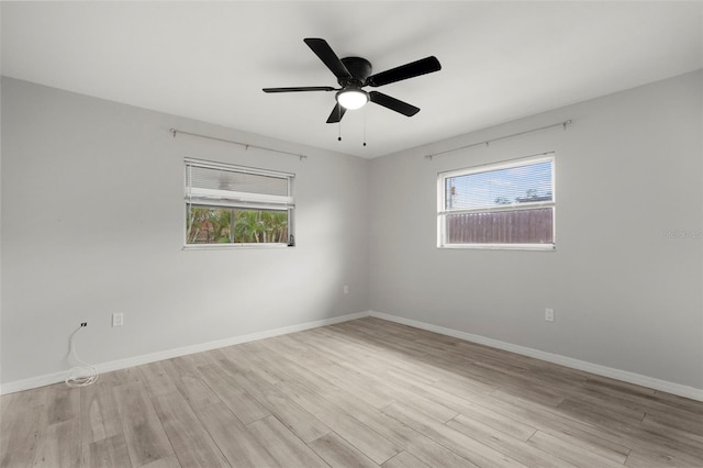 spare room with ceiling fan and light wood-type flooring