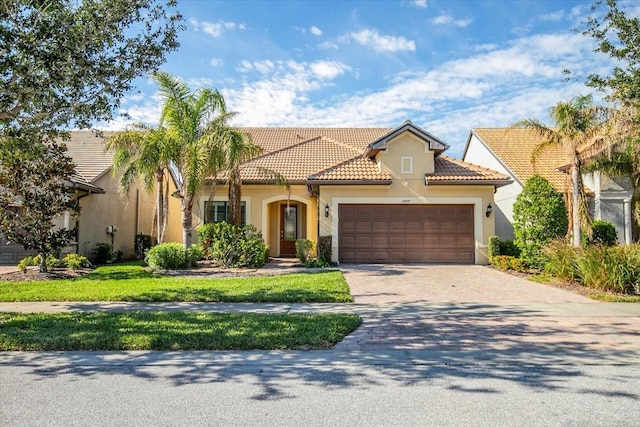 mediterranean / spanish house with a garage