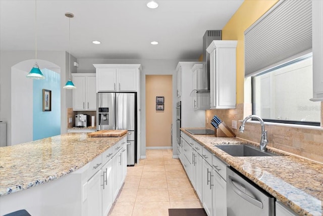 kitchen with white cabinetry, sink, stainless steel appliances, backsplash, and pendant lighting