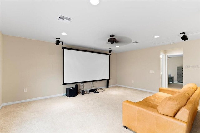 home theater room featuring light colored carpet and ceiling fan