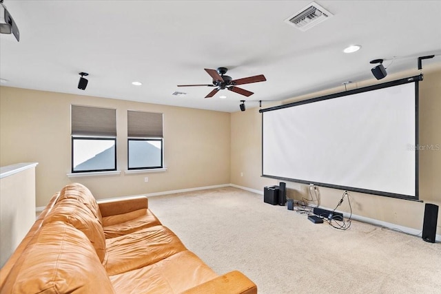 carpeted home theater with ceiling fan