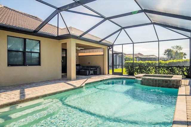 view of pool featuring glass enclosure, an in ground hot tub, and a patio