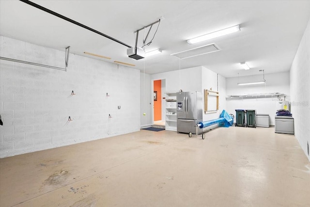 garage featuring stainless steel fridge and a garage door opener