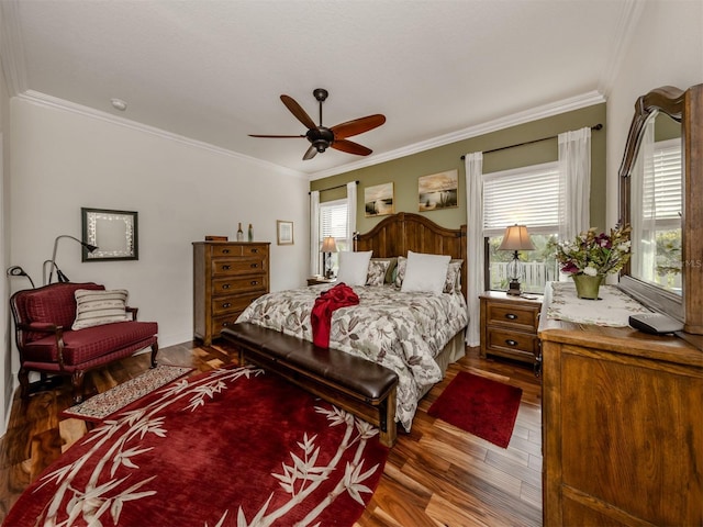 bedroom with ceiling fan, wood-type flooring, and crown molding