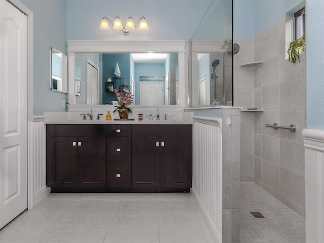 bathroom with vanity, tile patterned floors, and tiled shower