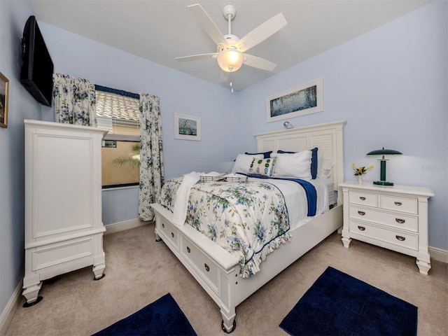 bedroom featuring ceiling fan and light colored carpet