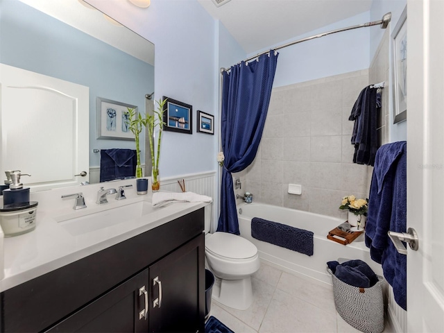 full bathroom featuring toilet, shower / bathtub combination with curtain, tile patterned floors, and vanity