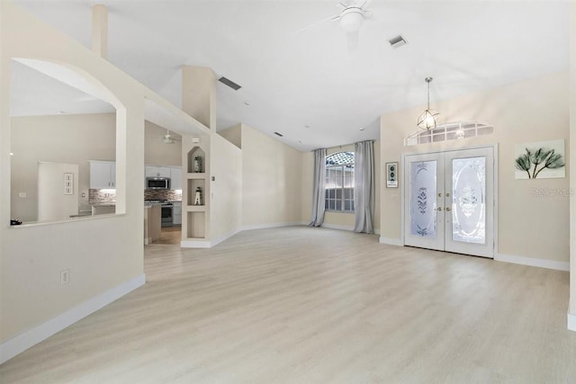 entryway with ceiling fan, light wood-type flooring, and french doors