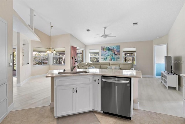 kitchen featuring stainless steel dishwasher, vaulted ceiling, sink, white cabinets, and an island with sink