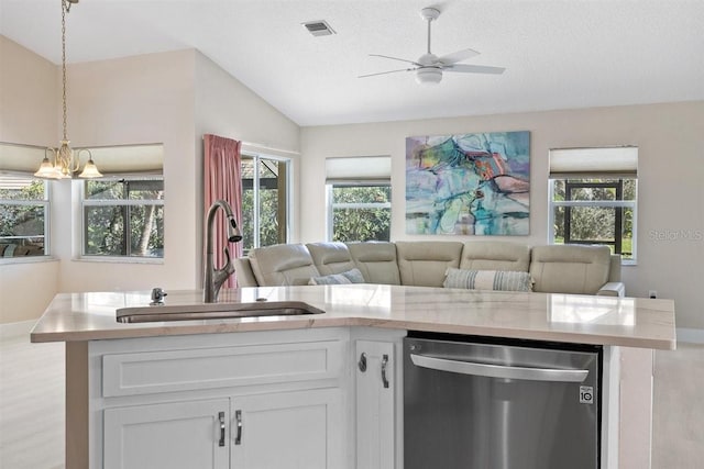 kitchen with dishwasher, sink, a textured ceiling, vaulted ceiling, and white cabinets