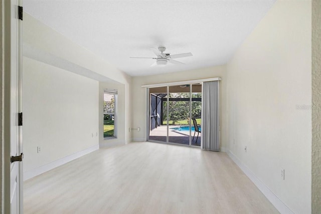 empty room featuring ceiling fan and light wood-type flooring