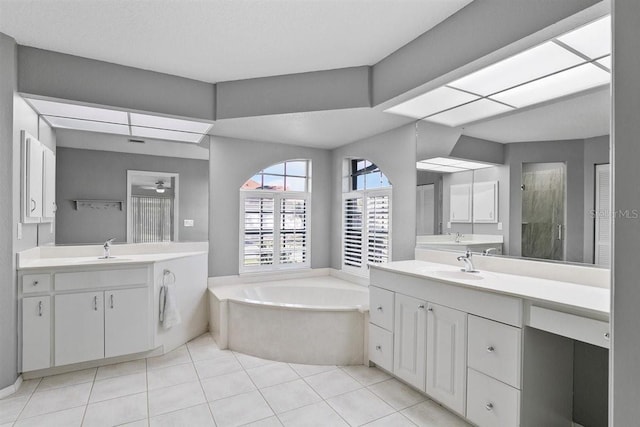 bathroom featuring vanity, tile patterned flooring, ceiling fan, separate shower and tub, and a textured ceiling