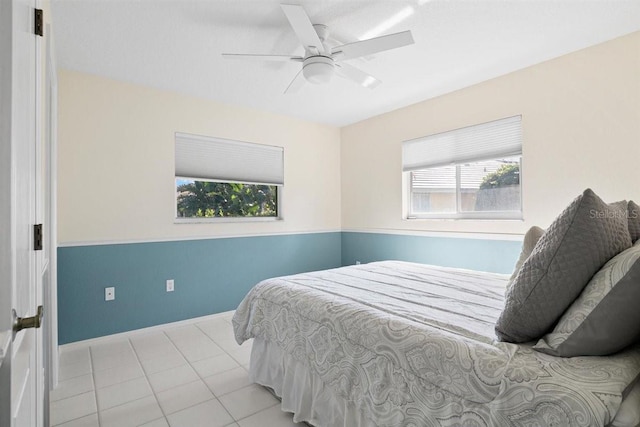 tiled bedroom featuring ceiling fan