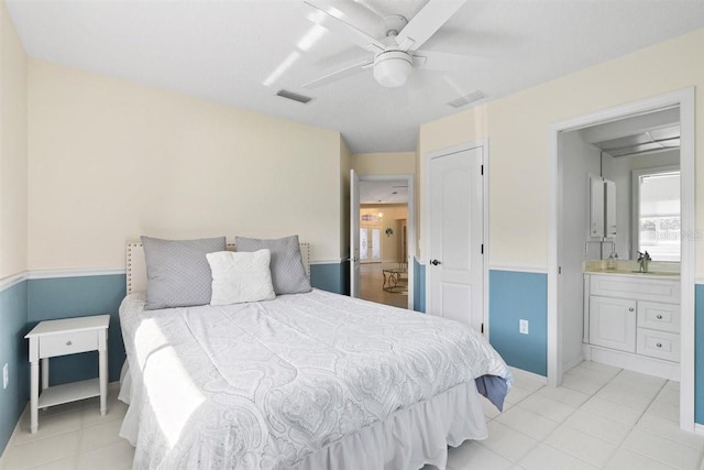 bedroom with connected bathroom, ceiling fan, and sink