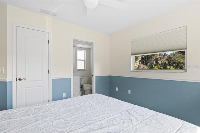 bedroom with ceiling fan and connected bathroom