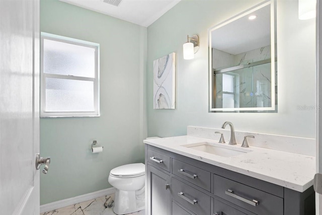 bathroom featuring vanity, an enclosed shower, and toilet