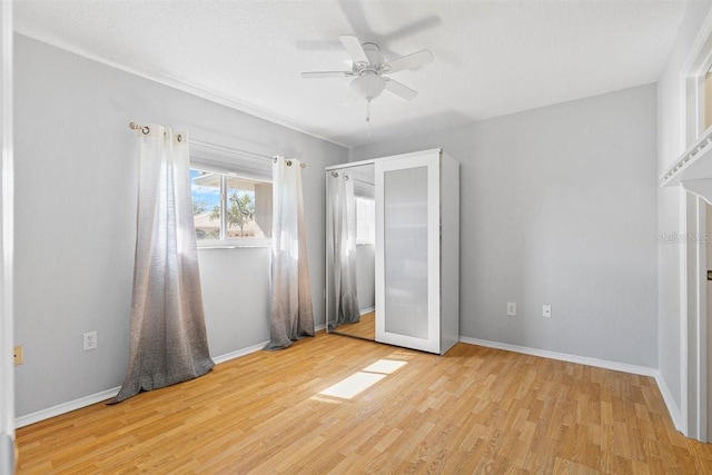 unfurnished bedroom with light hardwood / wood-style floors and ceiling fan