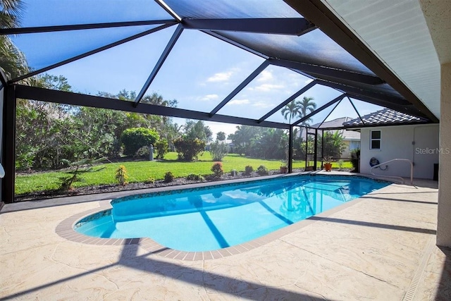 view of pool with a yard, a patio, and a lanai