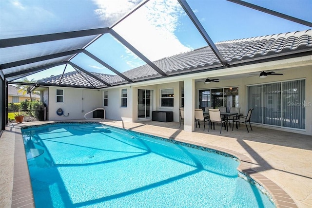 view of swimming pool with a patio, ceiling fan, and a lanai