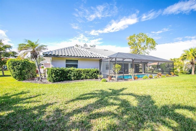 back of property featuring a yard and a lanai