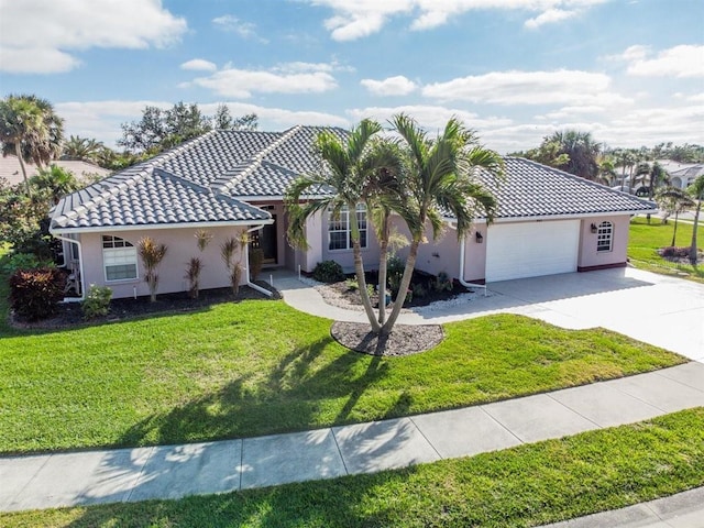 view of front of house featuring a garage and a front lawn