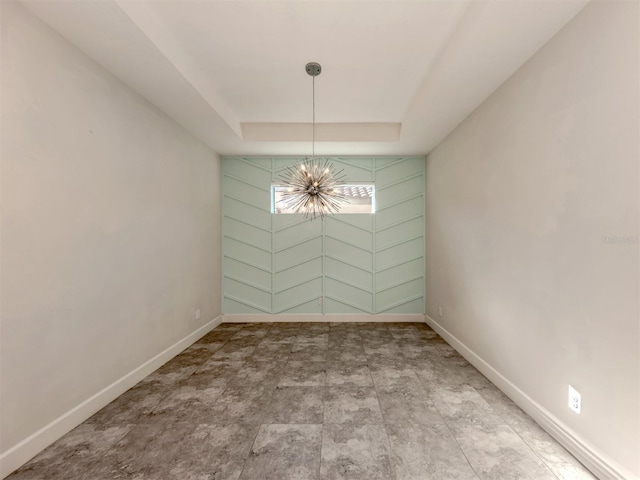 5733 Semolino St, Nokomis, FL 34275 - unfurnished room with a chandelier, baseboards, and a raised ceiling