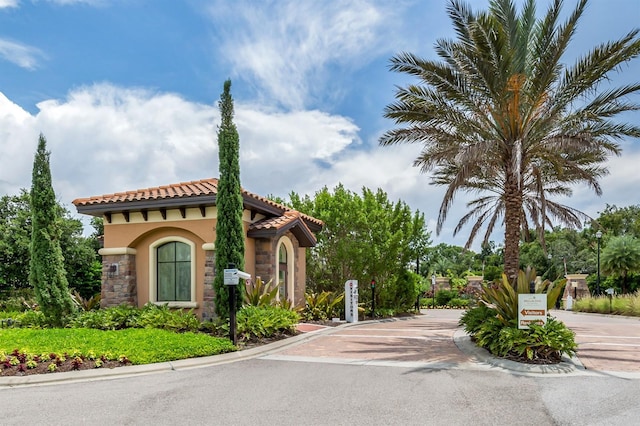 5733 Semolino St, Nokomis, FL 34275 - view of front of property featuring stucco siding, a tiled roof, and stone siding