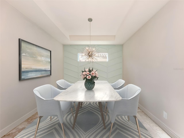 5733 Semolino St, Nokomis, FL 34275 - dining space featuring a chandelier, baseboards, and a raised ceiling
