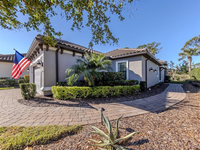 5733 Semolino St, Nokomis, FL 34275 - view of front of property with a garage, stucco siding, and a tile roof