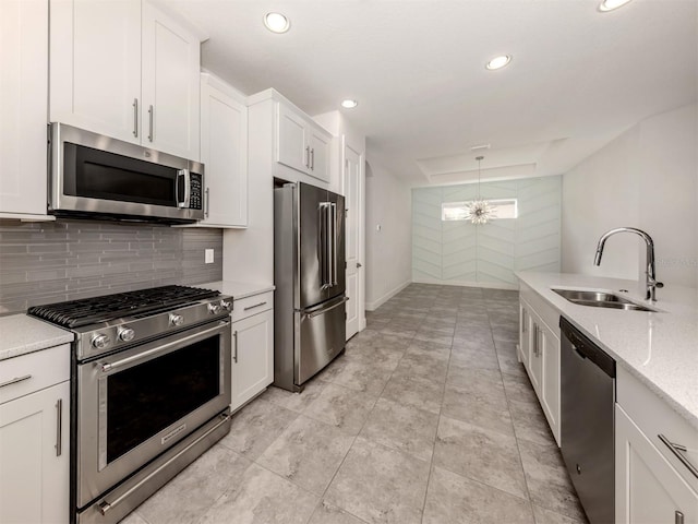 5733 Semolino St, Nokomis, FL 34275 - kitchen with appliances with stainless steel finishes, a sink, recessed lighting, white cabinetry, and decorative backsplash