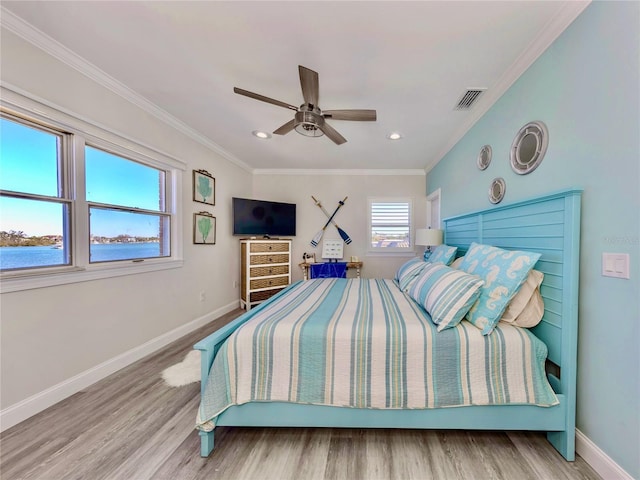 bedroom featuring ceiling fan, wood-type flooring, and crown molding