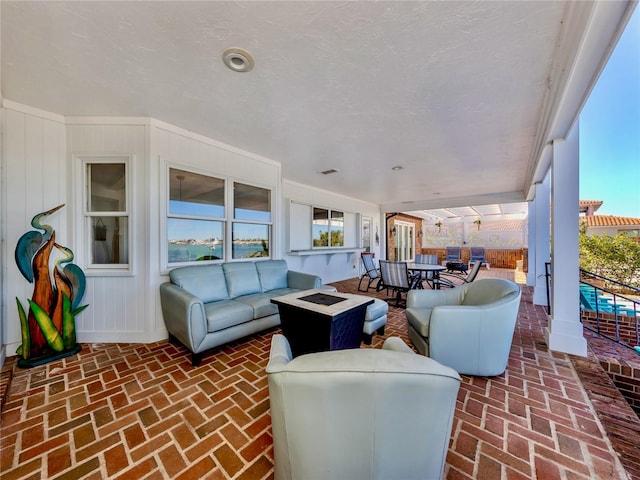 view of patio / terrace with an outdoor living space with a fire pit