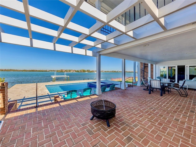 view of patio featuring a water view, an outdoor fire pit, and a pergola