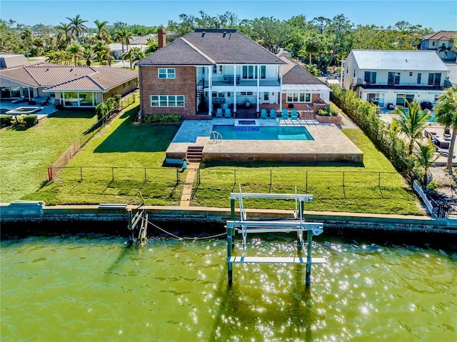 back of property with a water view, a fenced in pool, a balcony, and a patio