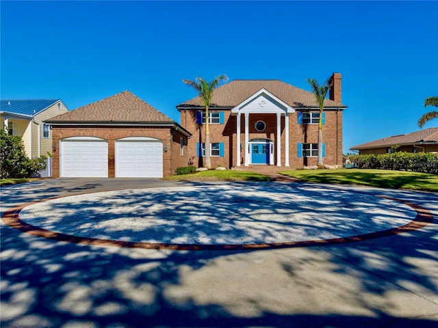 neoclassical home featuring a garage