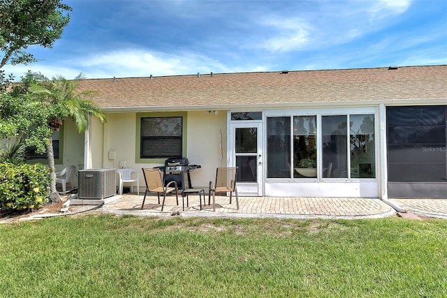 rear view of house with a lawn and cooling unit