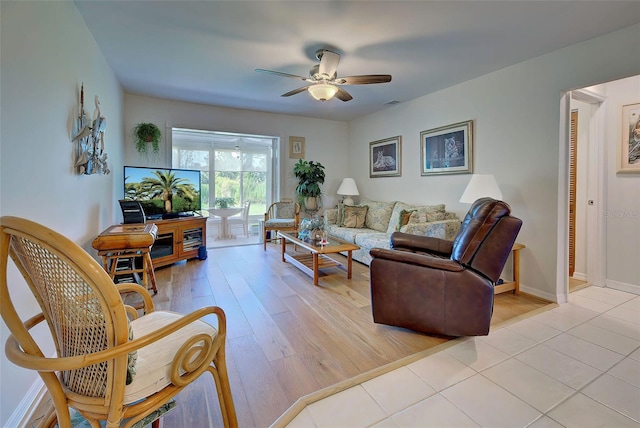 living room featuring ceiling fan and light wood-type flooring